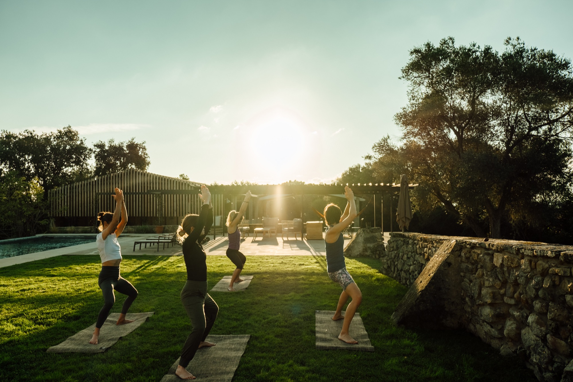 Sunset yoga session by the swimming pool